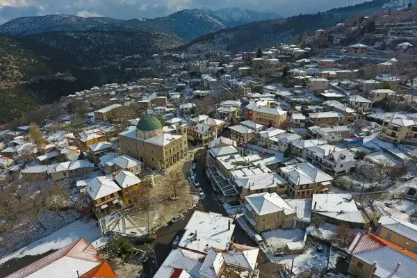 Snowy rooftops and church dome of Agios Petros village, Arcadia