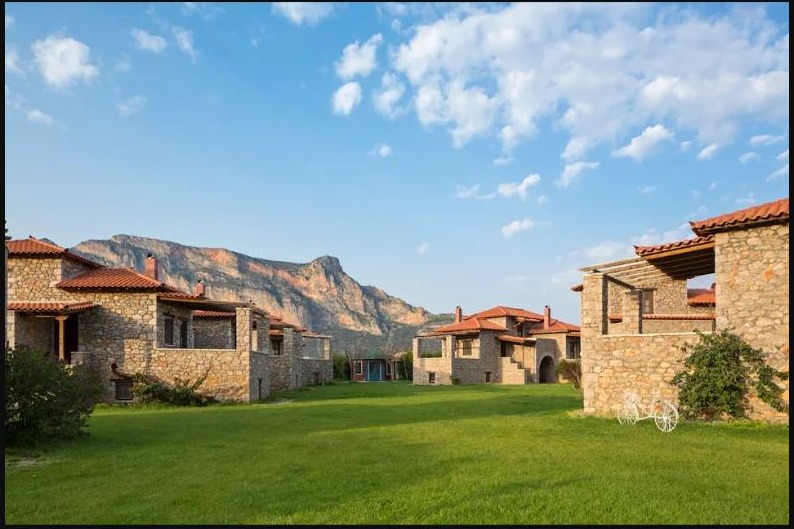 Stone guesthouses of Agroktima Leonidio with mountain backdrop