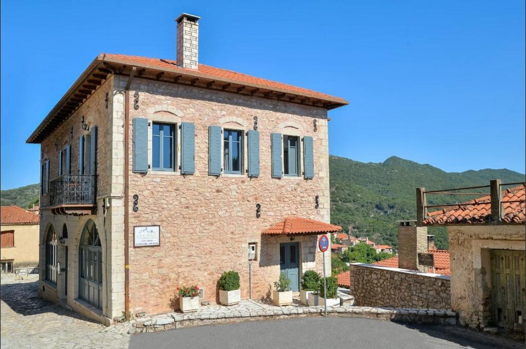 Kaza Guesthouse, a restored stone mansion on a street in Dimitsana
