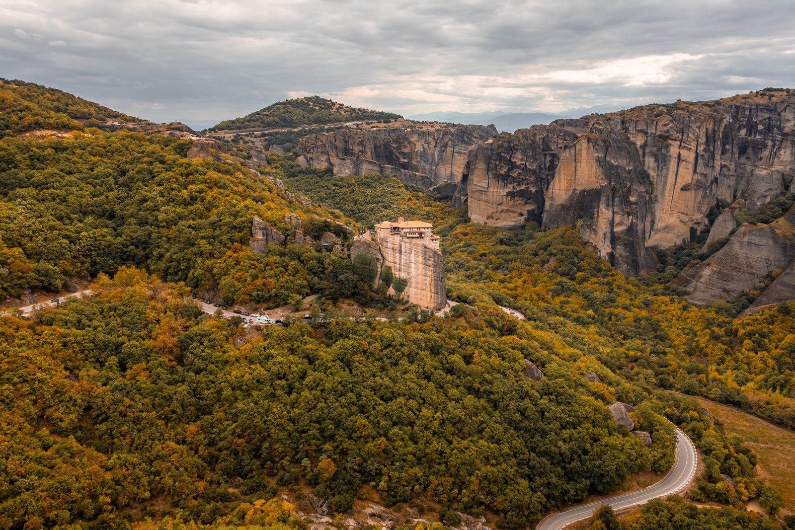 Stunning aerial view of Meteora monasteries nestled in autumnal landscape, Greece.