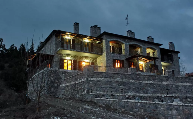 Thisoa Hotel, a stone and wood retreat on Mount Mainalon, at dusk