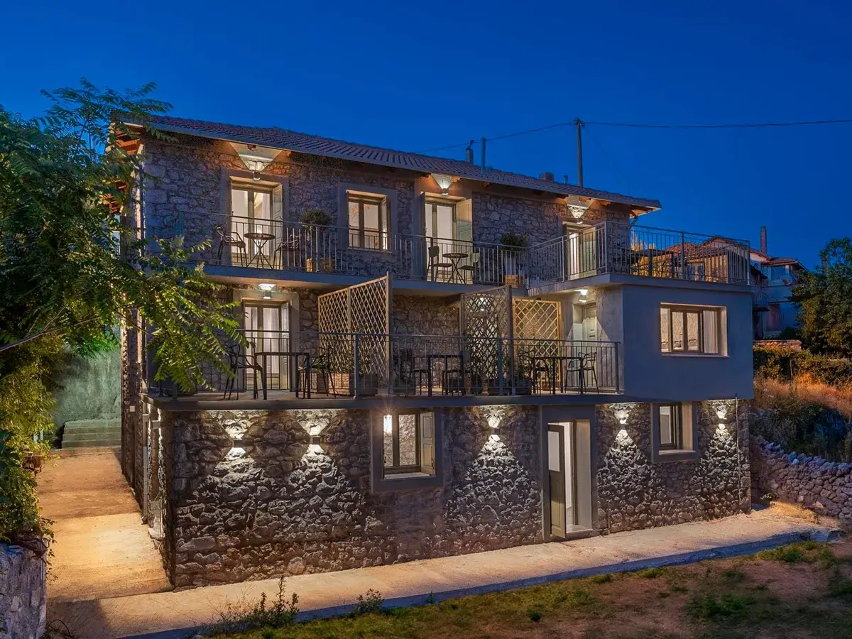 Arca Deorum stone building lit at night in Vytina, Arcadia