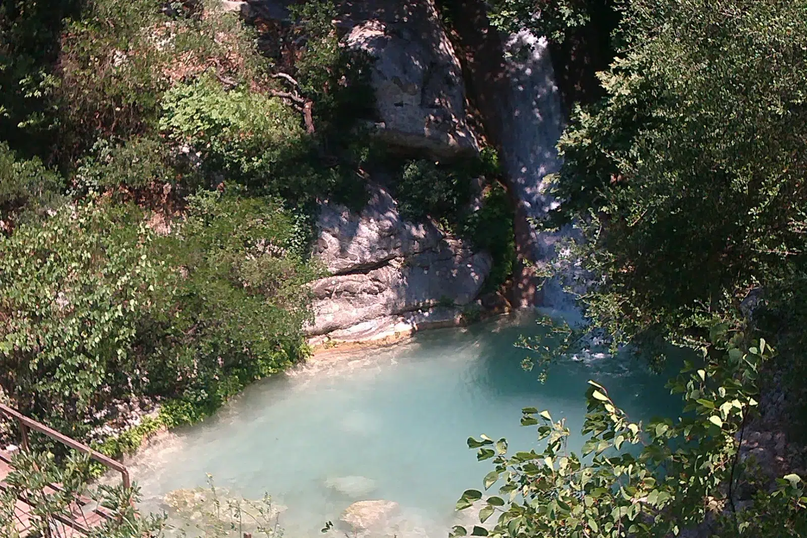 Emerald pool below the Neda waterfalls