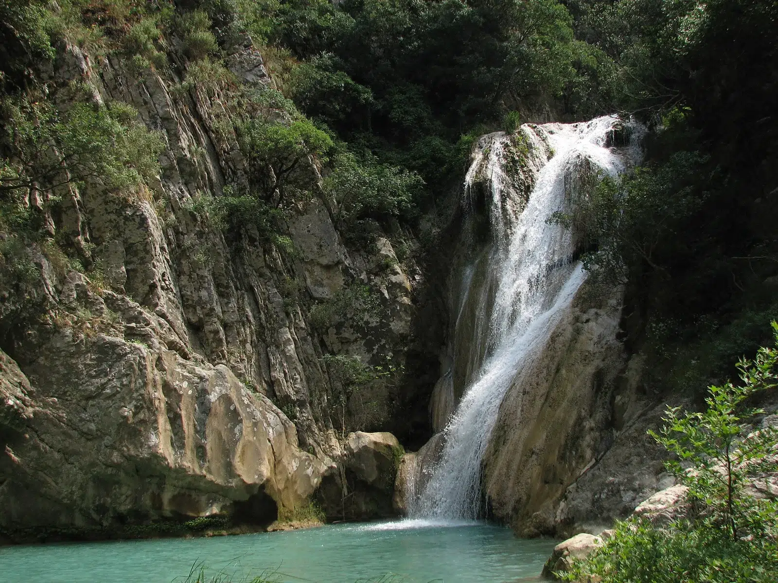 The stream of Polylimnio among rocks and trees, Messinia